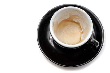 Stain of coffee in black cup on white background isolated