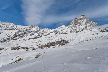 Fototapeta na wymiar Mountain skiing - view at Matterhorn, Italy, Valle d'Aosta, Breuil-Cervinia, Aosta Valley, Cervinia