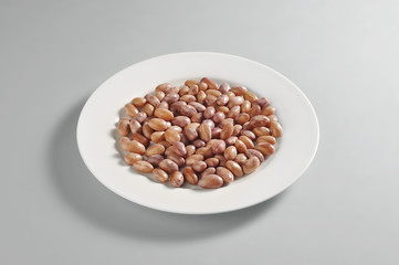 Round dish with a portion of boiled borlotti beans