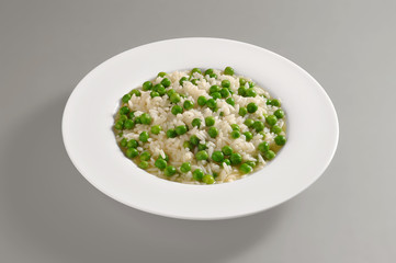 Round dish with boiled rice and peas