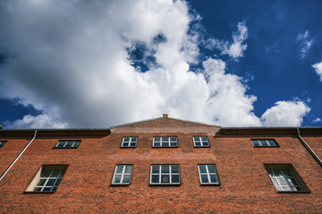 Fototapeta na wymiar Facade of red brick building against the blue sky, Scandinavian architecture, Denmark