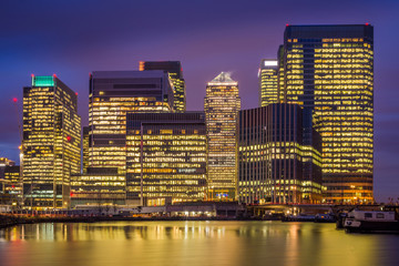London, England - The skyscrapers of Canary Wharf, the famous financial district of London at blue...