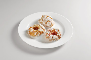 Round dish with three almond pastry cookies