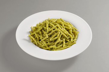 Round dish with trofie pasta with Pesto genoese