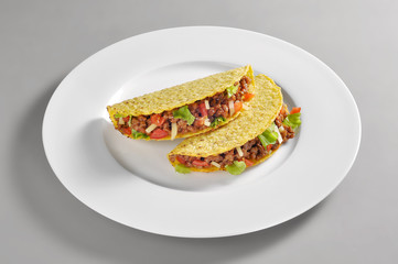 Round dish with two mexican tacos