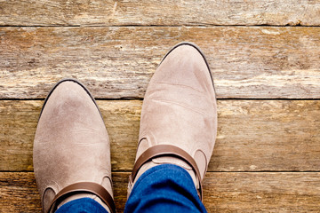 Women's country and western boots on rustic wooden background