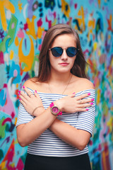 cheerful young woman with round glasses