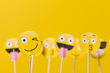 Emoji smiley social media characters on a yellow background - obrazy, fototapety, plakaty