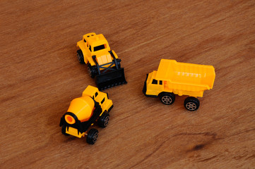Group of small heavy construction machine toy, lorry, bulldozer and concrete mixer. All made of...