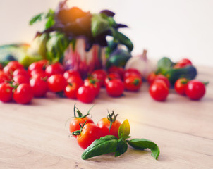 Fresh Basil and tomatoes. Cooking at Home. Preparing Healthy Salad with Basil and Tomatoes. Bunch of Basil, garlic, onions. Italian style composition. Fresh italian vegetables.
