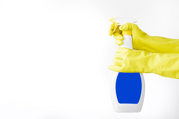Hand in rubber yellow glove holds  spray bottle of liquid detergent on white background. cleaning