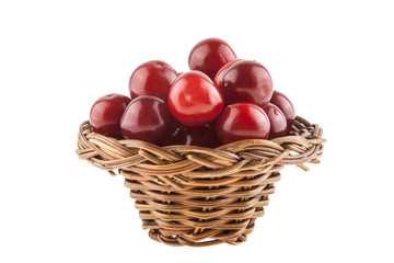 Cherries in a wicker basket isolated on a white background