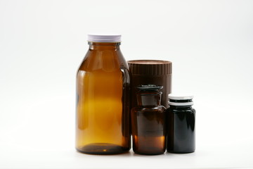 Amber bottles with cap on white background