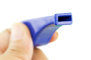 hand holding a whistle, sport concept.