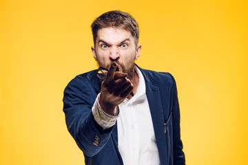 Business man with a beard on a yellow background, emotions