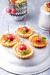 Apple caramel little tarts on grey background. French tatin with paradise apple.
