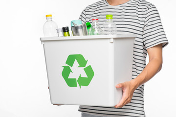 Eco concept. Male hands holding recycling bin full of recyclable items isolated on a white...