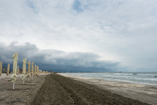 Landscape with sea view, waves and sea shells, clouds, photographed in Mamaia, Romania, in cloudy spring day