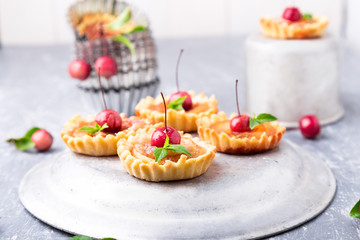 Apple caramel little tarts on grey background. French tatin with paradise apple.