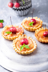 Apple caramel little tarts on grey background. French tatin with paradise apple.