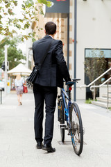 Young businessmen with a bike