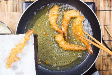Chef putting frying shrimp Tempura to the plate