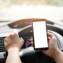 Hand is holding a touch phone with isolated screen in the car.