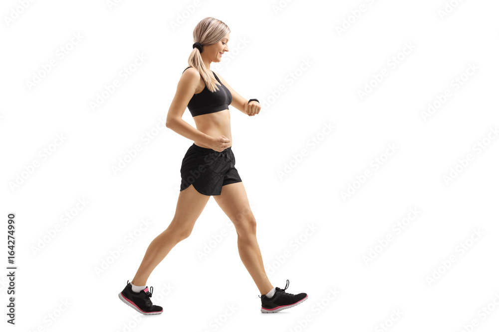 Canvas Prints Woman walking and checking her sports watch