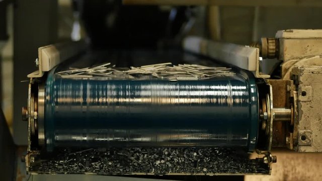 Metal waste of the metal punching machine on a conveyor belt