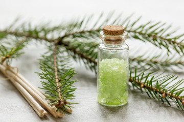 fir branches and spruce bath salt on white table background