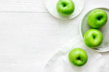 Healthy green food with apples on plates white background top view mock up