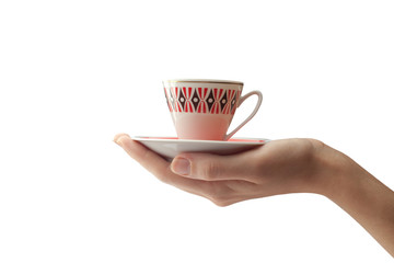 A female hand holds a cup and a saucer in the palm of your hand