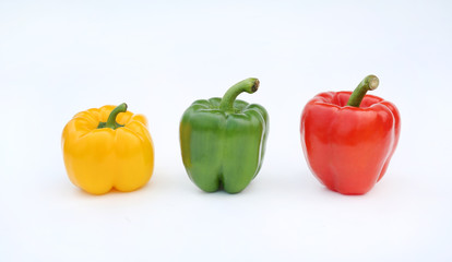 Green, red and yellow bell pepper isolated on white background.