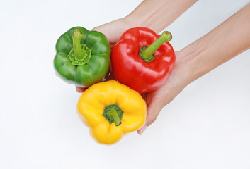 Hand holding Bell peppers isolated on white background.