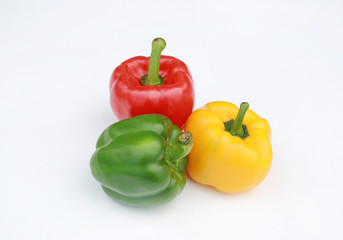 Green, red and yellow bell pepper isolated on white background.