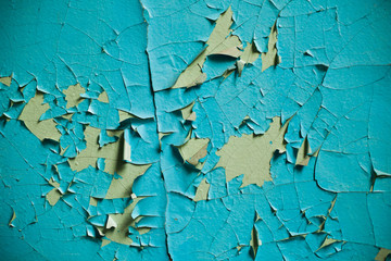 Cracked wall with old layers of paint in abandoned house