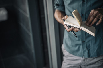 Close-up of businessman holding diary