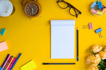 Office equipment on a yellow and golden paper desk