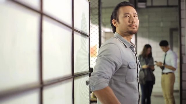 Asian Entrepreneur Walking Around Office Thinking