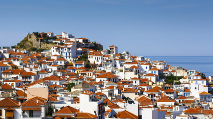 White houses with red roofs in Skopelos town, Greece.

