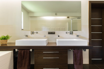Naklejka na ściany i meble Modern bathroom with dark furniture