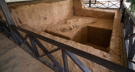 Ban Kao Neolithic burial site in Kanchanaburi, Thailand displays skeletons pots and axes