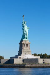 Fototapeta na wymiar Statue of Liberty and Liberty Island in a sunny day, blue sky in New York