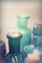 Coloured glass bottles on a rustic background