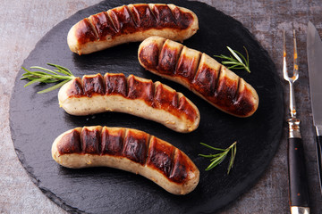 Grilled sausages with sauce ketchup on a wooden table - Home-made Pork Sausages