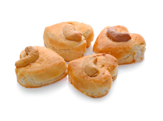 Obraz na płótnie Canvas Heart-shaped cookies Cashews put on top on white background