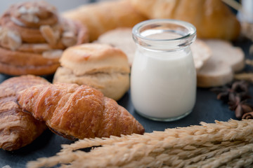 fresh bread and baked goods on wooden chopping board, rustic style