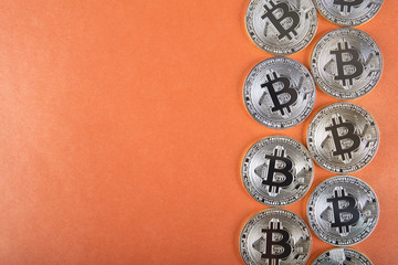 Golden Bitcoins (digital virtual money) on red background.