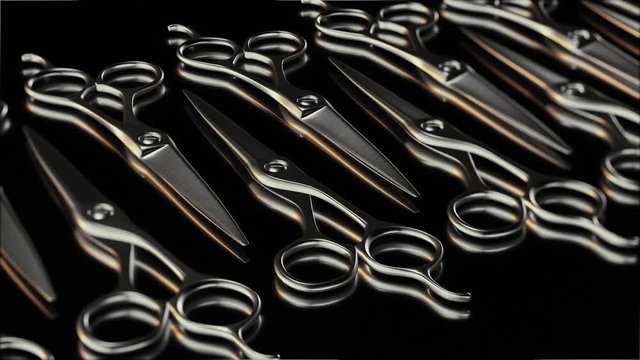 Seamlessly looping pan over and endless line of shiny hairdressers scissors on a bright reflective surface.
