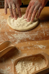 The chef prepares dough for fettuccine , soup and pizza